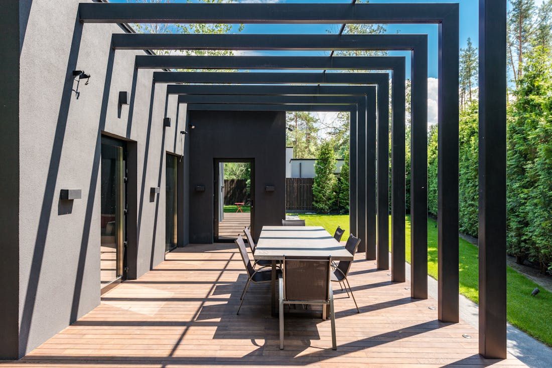 Covered patio with pergola structure and outdoor dining